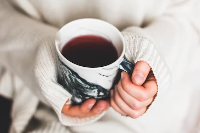 Person holding cup of coffee