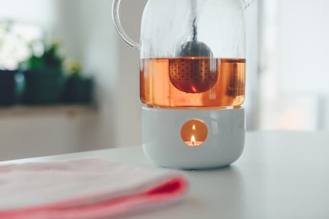 Tealight candle with white holder on table